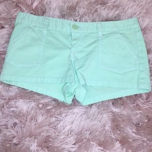 Mint green shorts.